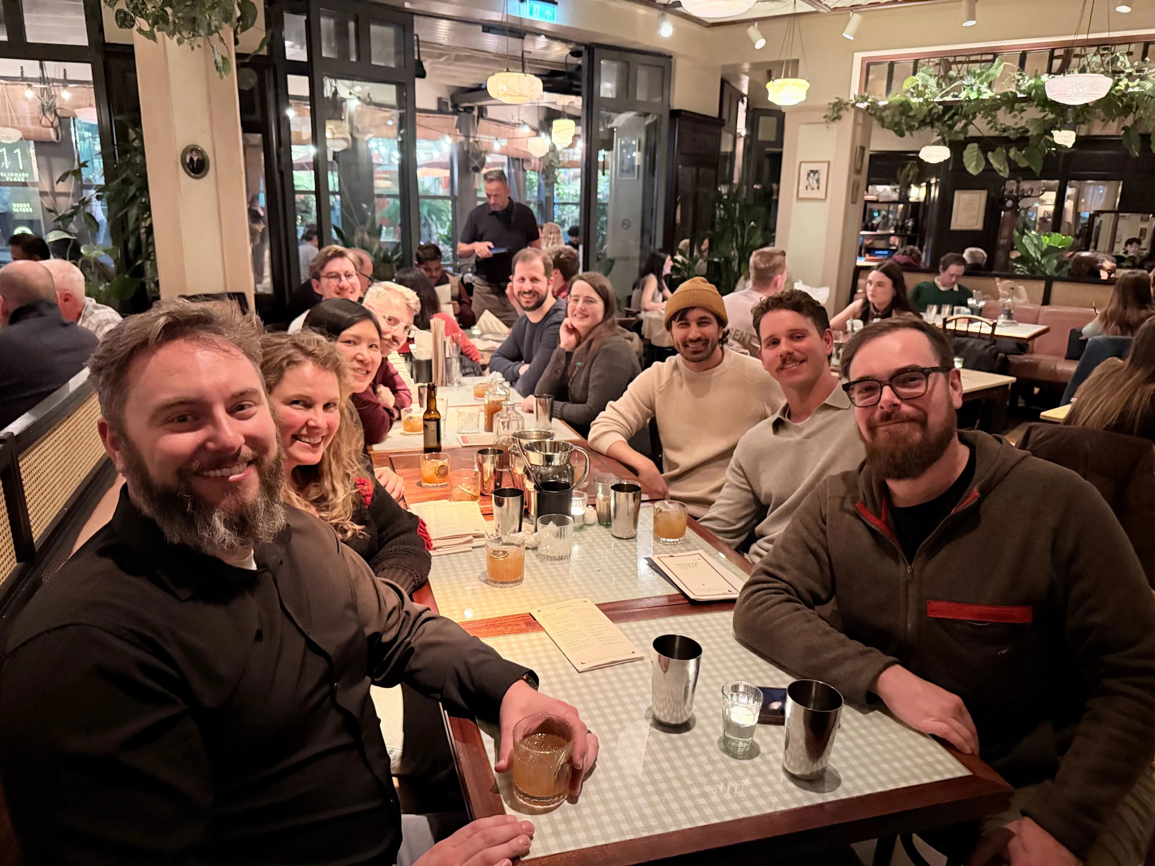 Nick Nisi, Zack Proser, and teammates at dinner in London