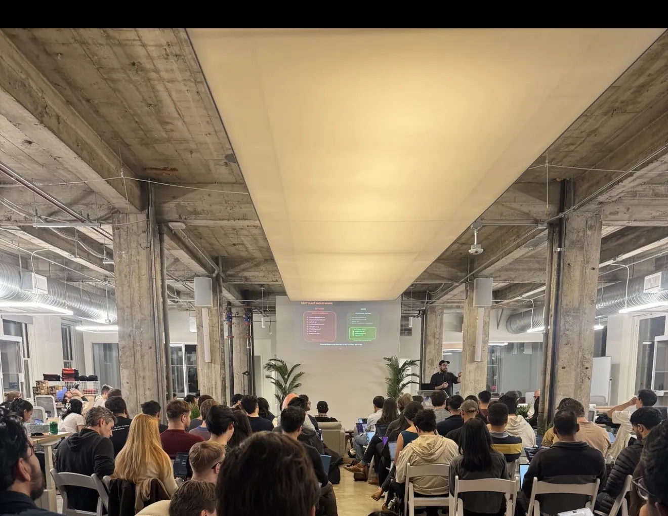 View from the audience at the Claude Cowork GTM Workshop — attendees following along on laptops as Zack presents
