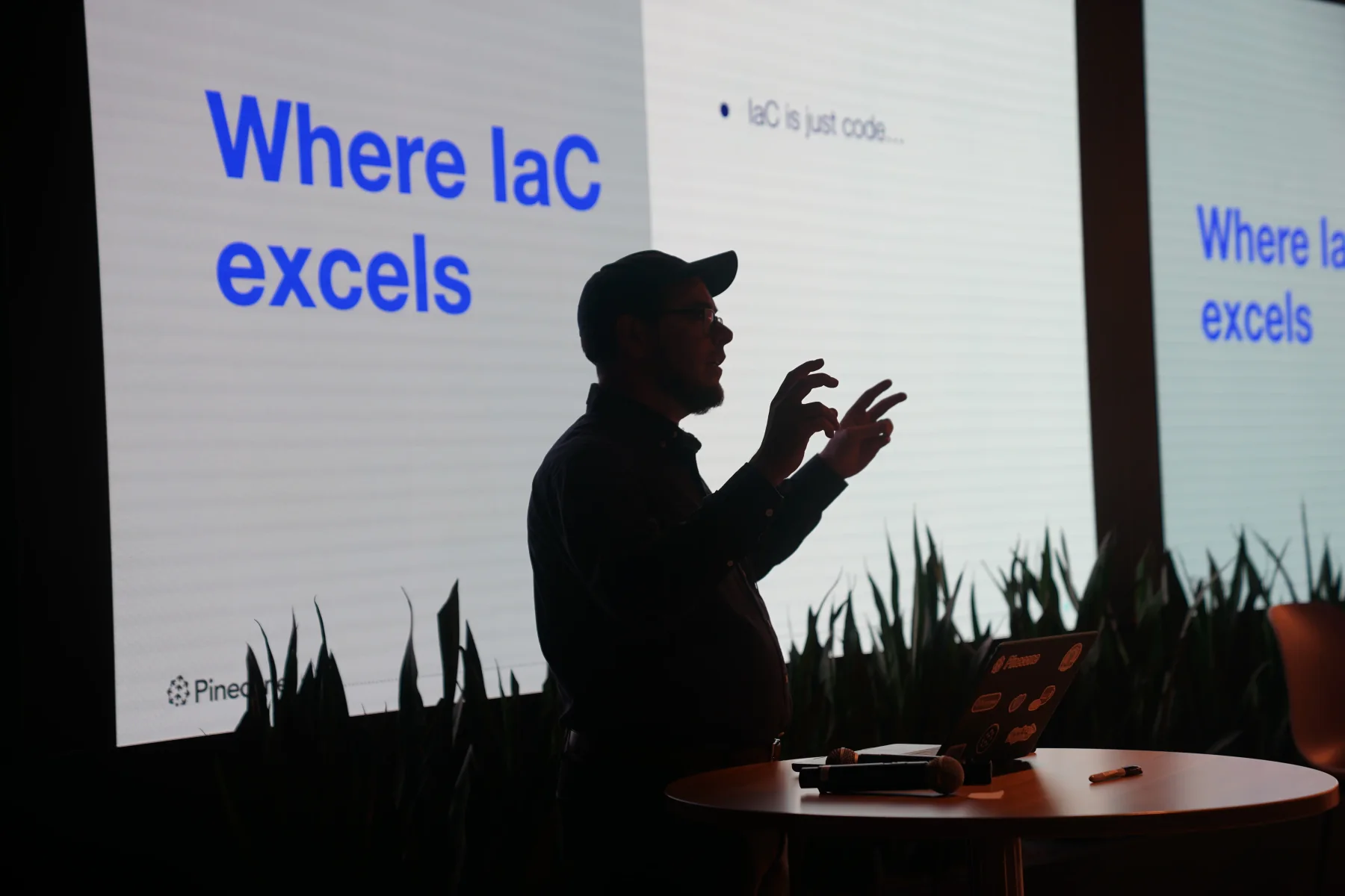 Zack gesturing while presenting a slide about where infrastructure as code excels.