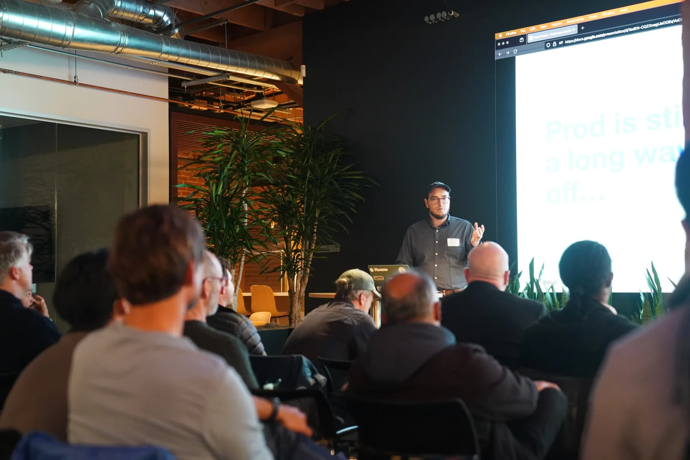 Zack explaining a technical slide to attendees at a16z.