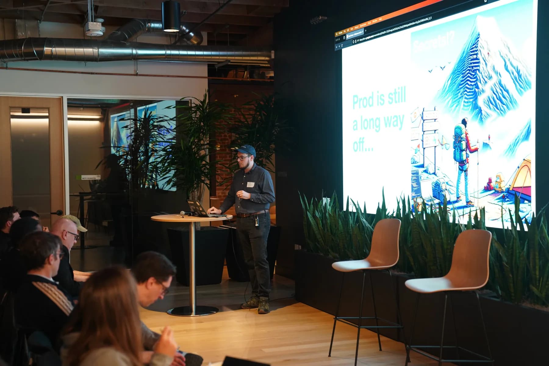 Zack speaking beside the projection screen about infrastructure as code with Pulumi.