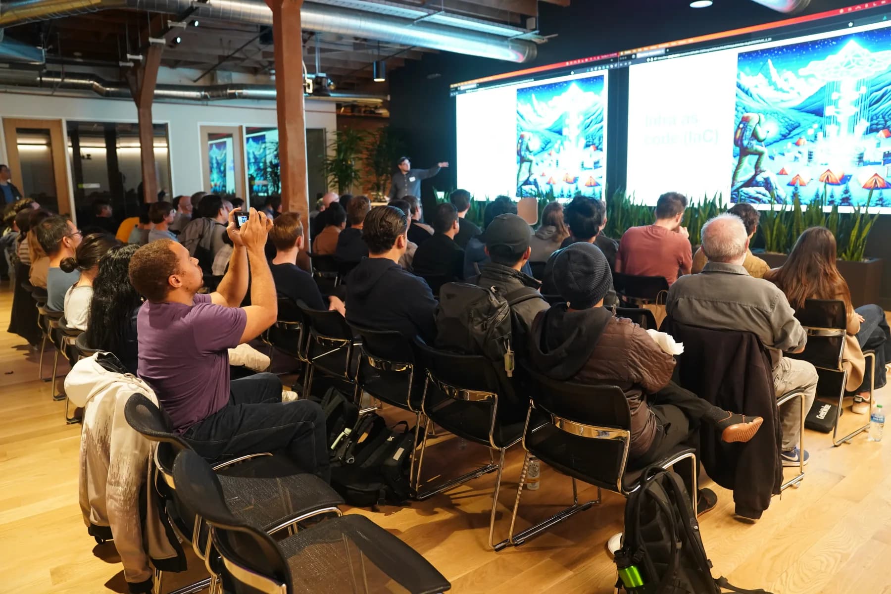 A full audience watching the technical talk in the a16z event space.