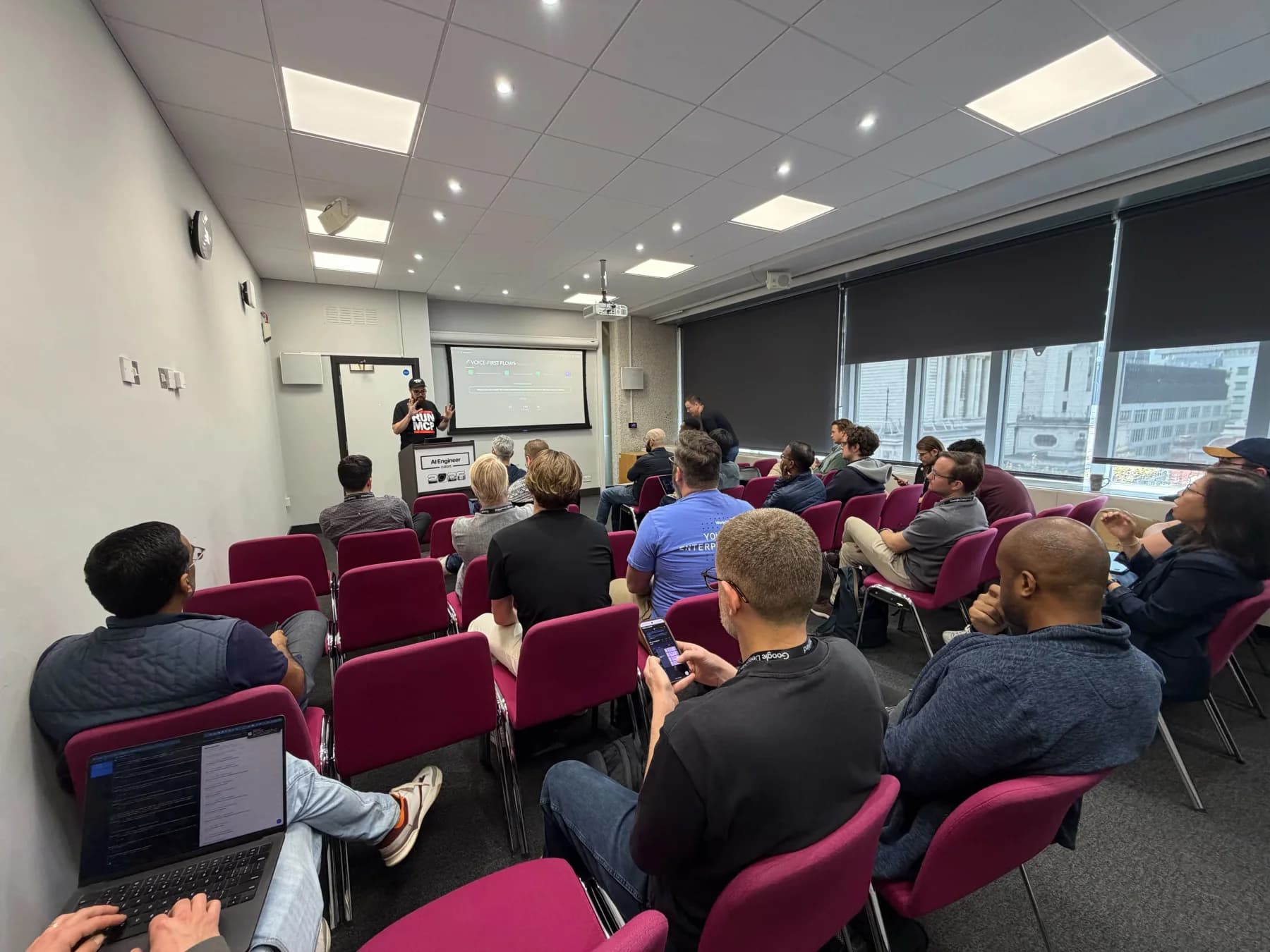 Attendees following a talk in the London workshop room.