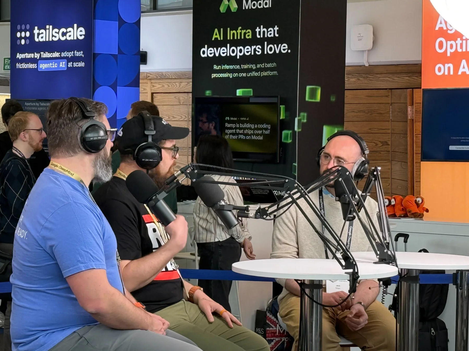 Zack and Nick recording a podcast with microphones and headphones at AI Engineer Europe.