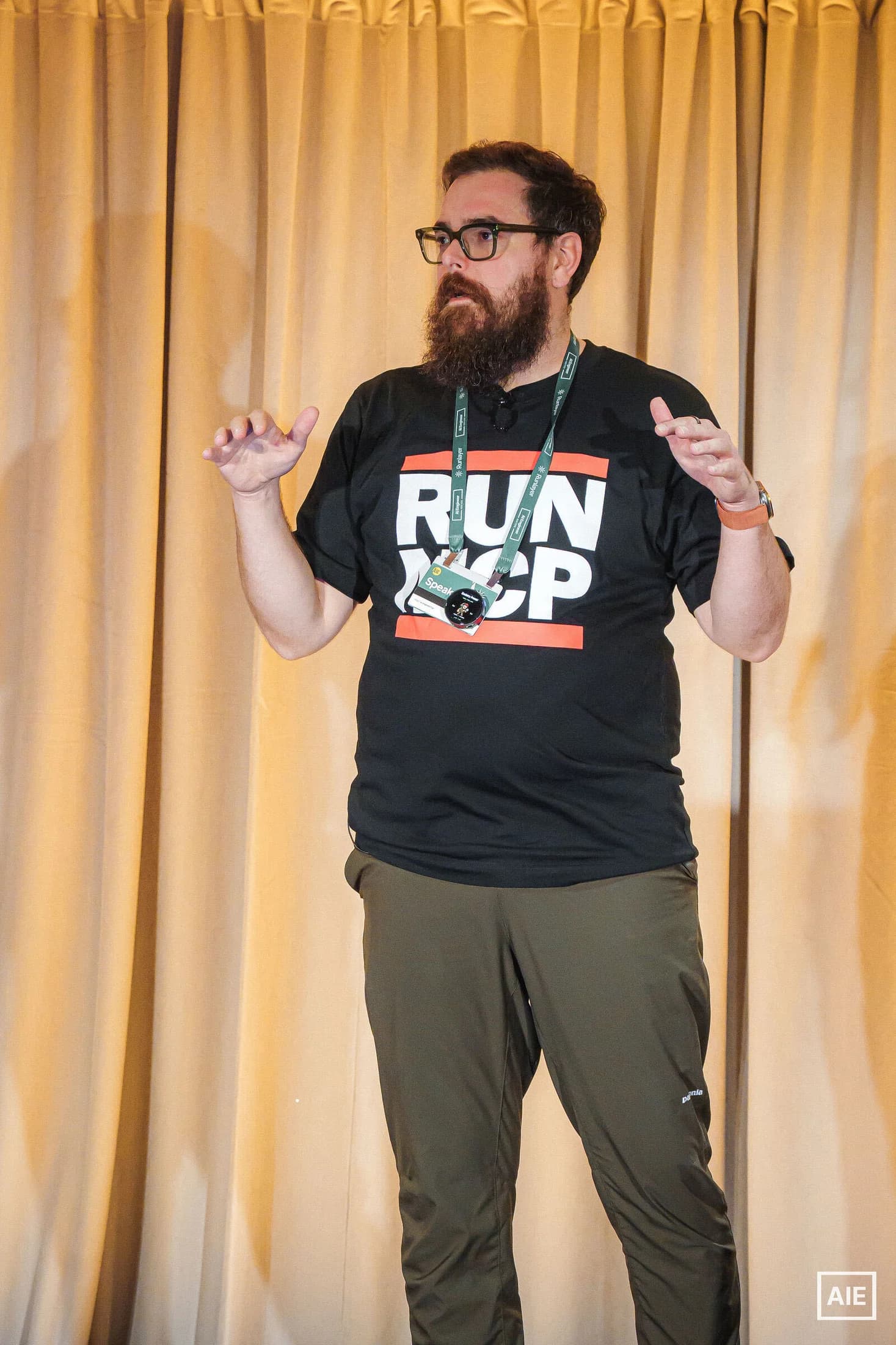 Zack explaining a concept with both hands while speaking at AI Engineer New York.