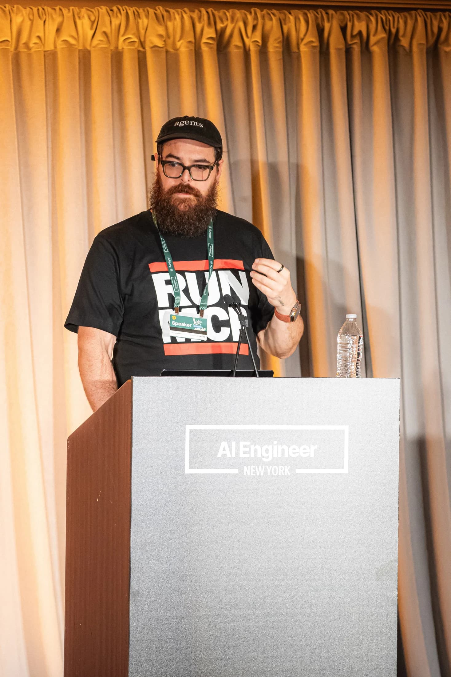 Professional portrait of Zack at the microphone during AI Engineer New York.