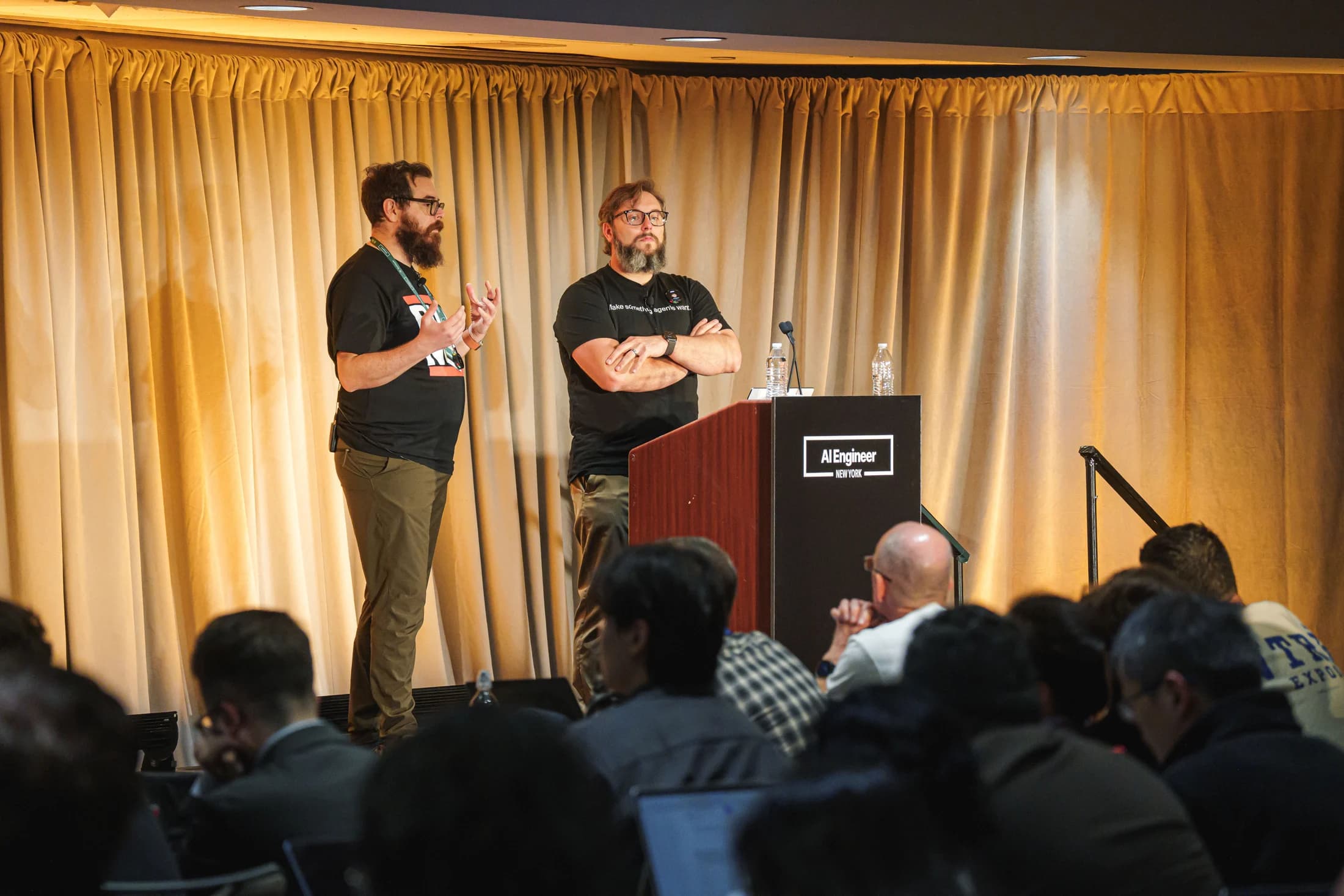 Zack and Nick on stage with the workshop audience in the foreground.