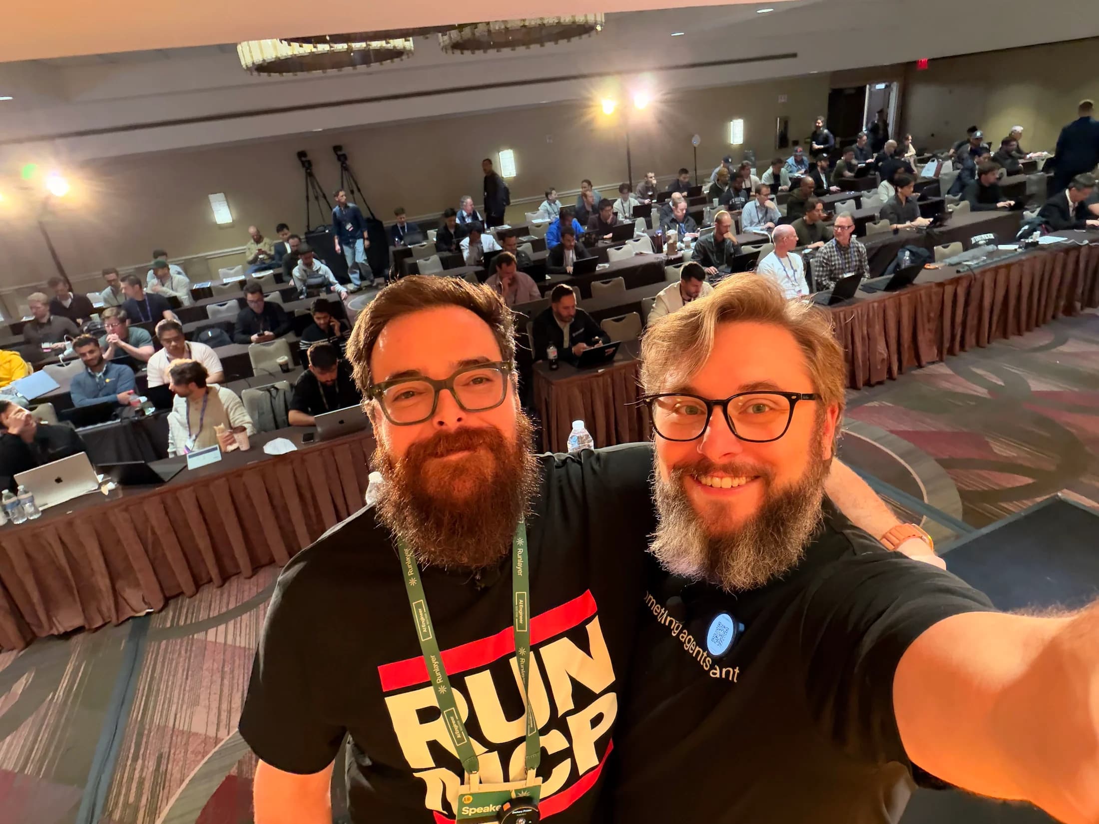 Zack and Nick take a photograph from the stage with a full New York workshop room behind them.