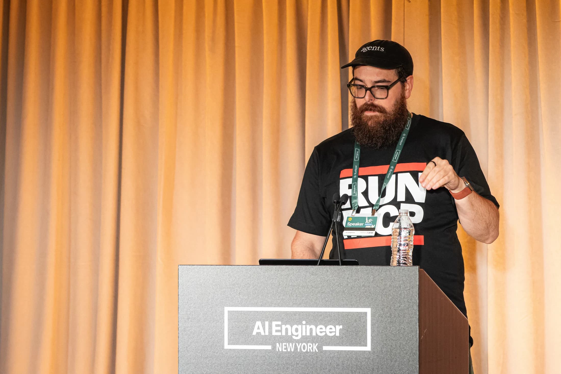 Zack speaking and gesturing from the AI Engineer New York lectern.